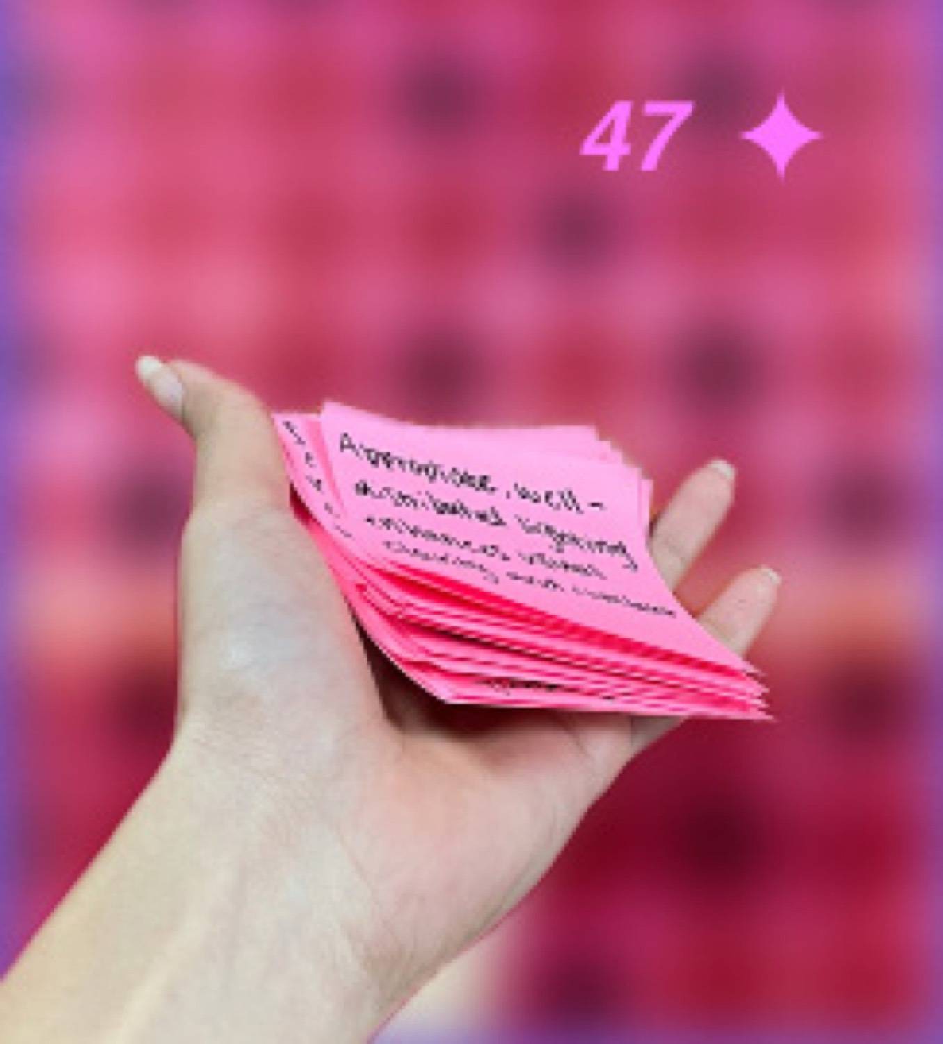 A hand holding the pink themes created during synthesis