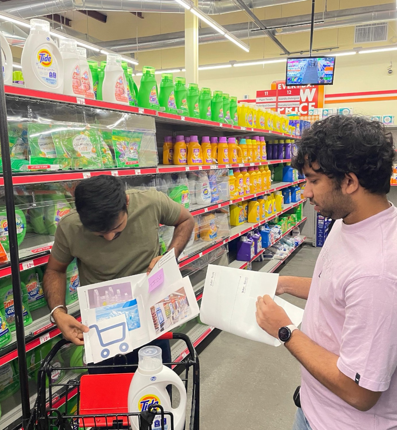 Researchers recording contextual observations in a retail aisle